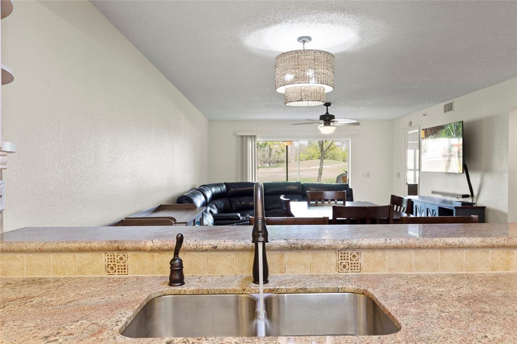 6611 Stone River Road, Unit 102 Bradenton, FL 34203 - Photo 7 of 23 a kitchen with counter top space and a sink