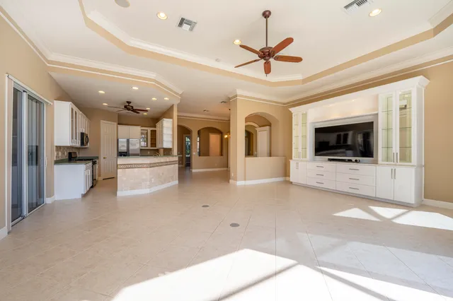 a spacious bedroom with a large bed and a dresser