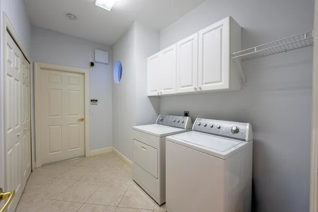 an aerial view of a house with swimming pool and porch