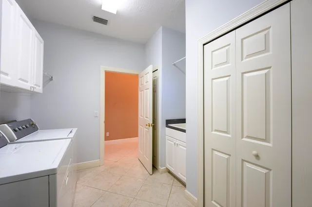 a front view of a house with swimming pool and porch with furniture