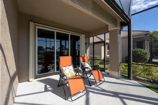 a view of house with a yard and sitting area
