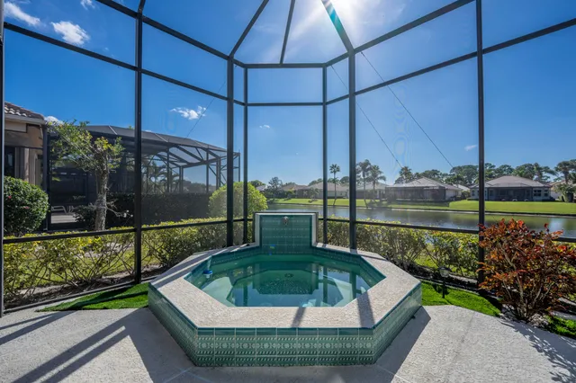 a view of a swimming pool with outdoor seating