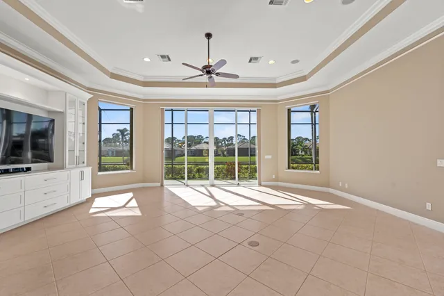 a living room with furniture kitchen view and a chandelier