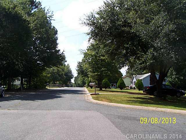 1607 Rushing Street Monroe, NC 28112 - Photo 4 of 4 a view of swimming pool with a bench and trees