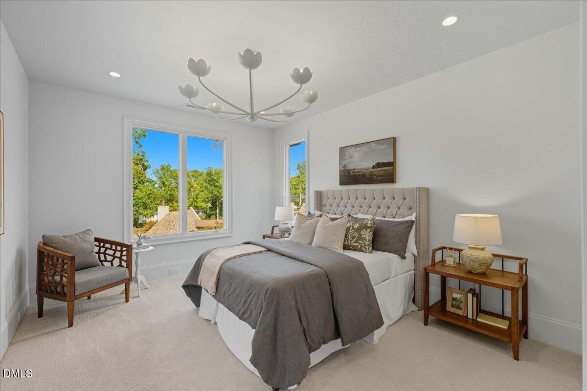 1216 Barcroft Place Raleigh, NC 27615 - Photo 50 of 91 a bedroom with bed and a chandelier
