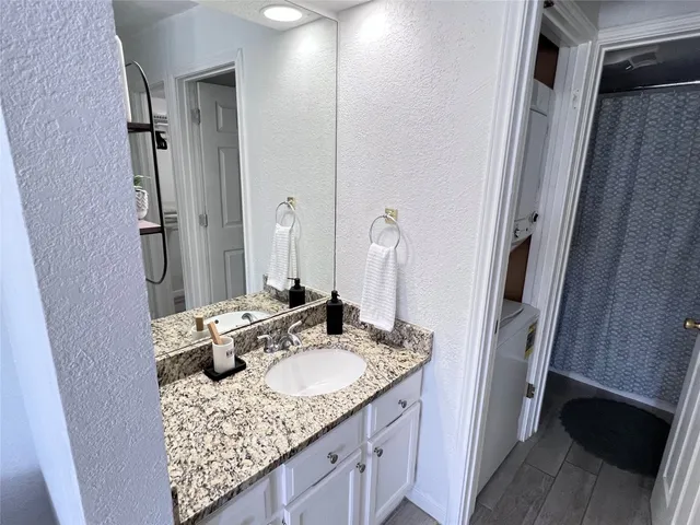 a bathroom with a sink double vanity granite and a mirror