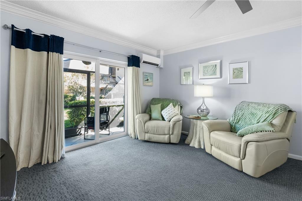 87 North Collier Boulevard, Unit B4 Marco Island, FL 34145 - Photo 11 of 31 a living room with furniture and a large window
