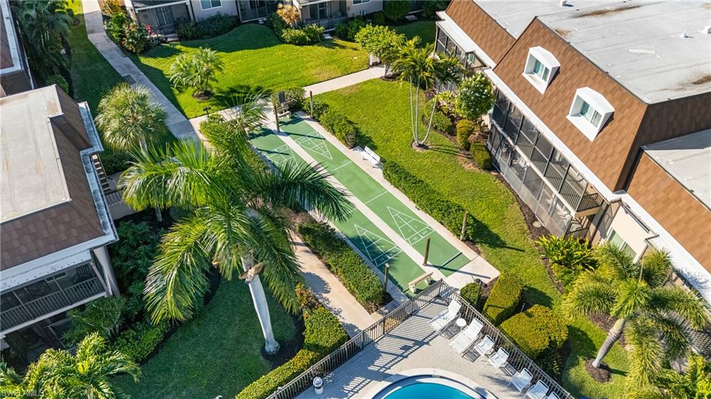 87 North Collier Boulevard, Unit B4 Marco Island, FL 34145 - Photo 21 of 31 an aerial view of a residential apartment building with a yard and potted plants