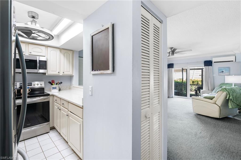87 North Collier Boulevard, Unit B4 Marco Island, FL 34145 - Photo 5 of 31 a kitchen with cabinets and window