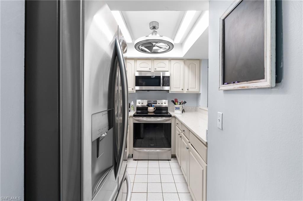 87 North Collier Boulevard, Unit B4 Marco Island, FL 34145 - Photo 6 of 31 a kitchen with stainless steel appliances granite countertop a stove and a sink