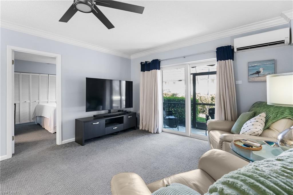 87 North Collier Boulevard, Unit B4 Marco Island, FL 34145 - Photo 10 of 31 a living room with furniture and a flat screen tv