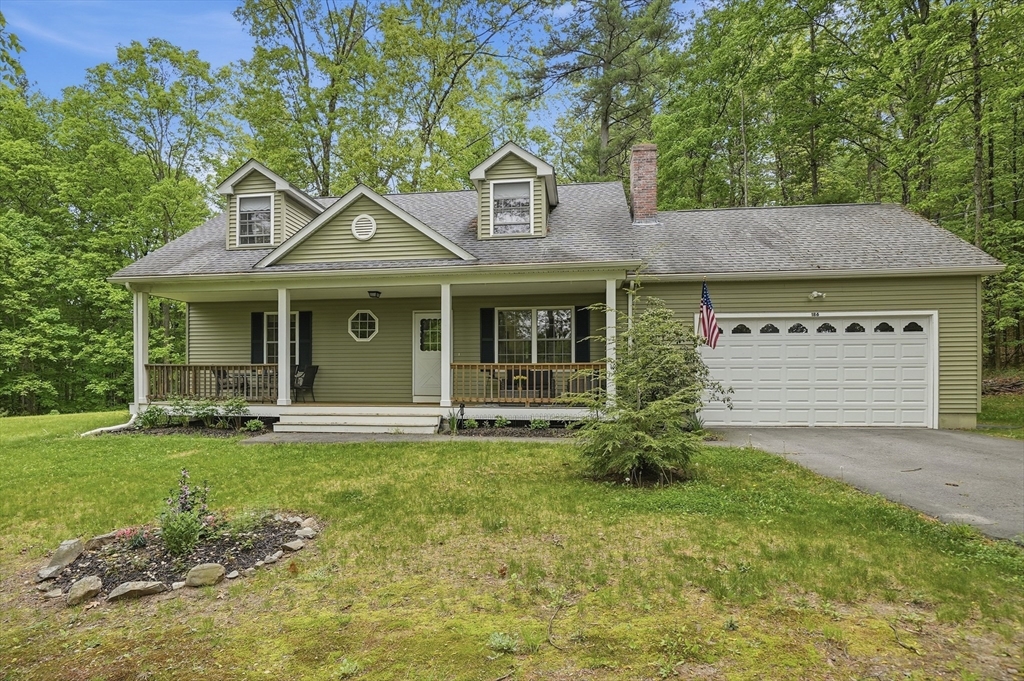 186 Common Street Groton, MA 01450 - Photo 4 of 28 a front view of a house with garden