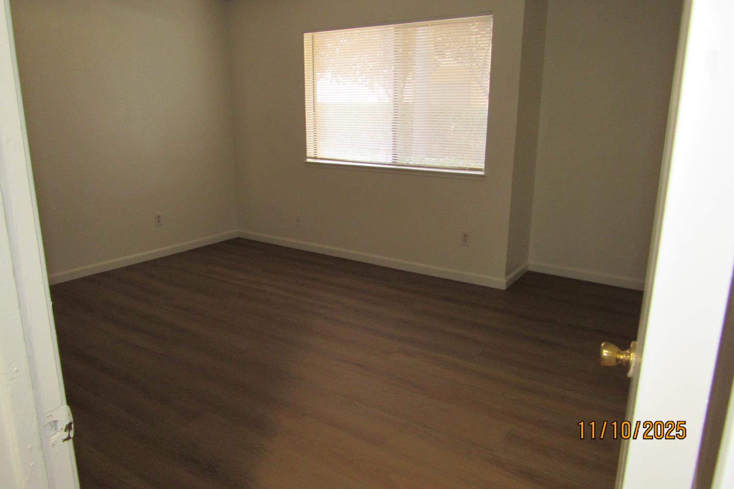 3400 Sullivan Court, Unit 106 Modesto, CA 95356 - Photo 12 of 18 an empty room with wooden floor and windows