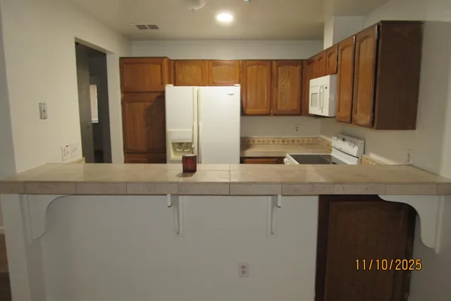 a kitchen with a sink and a refrigerator