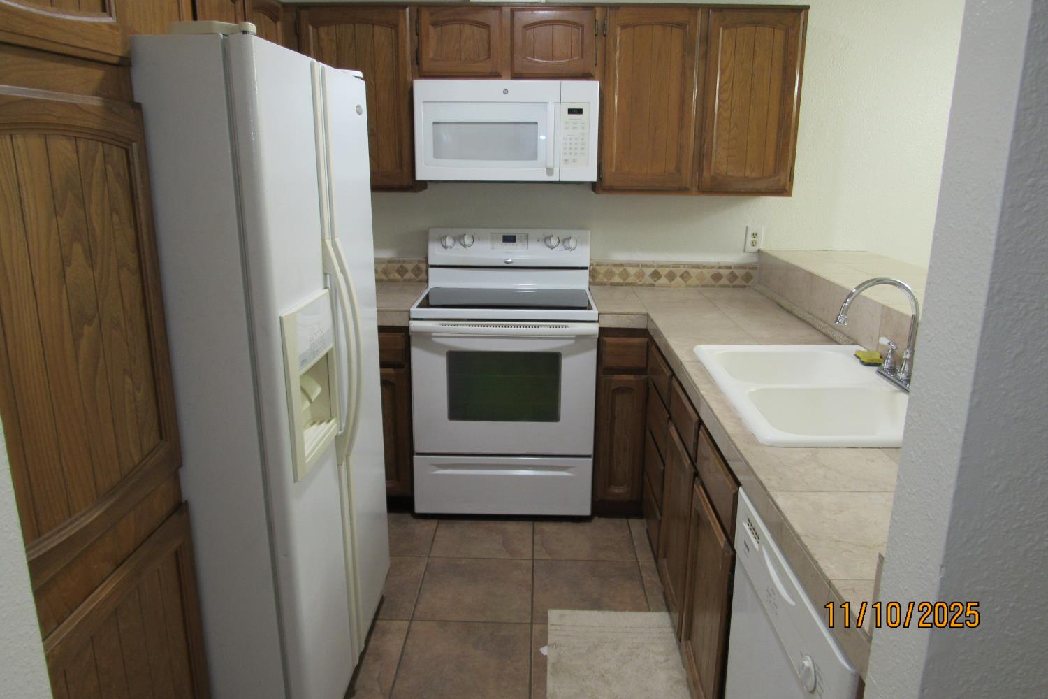 3400 Sullivan Court, Unit 106 Modesto, CA 95356 - Photo 6 of 18 a kitchen with a sink and a refrigerator