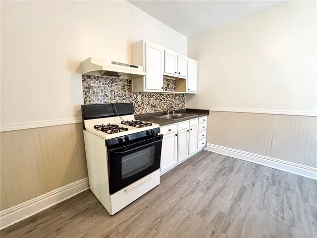a kitchen with stainless steel appliances granite countertop a stove and a sink