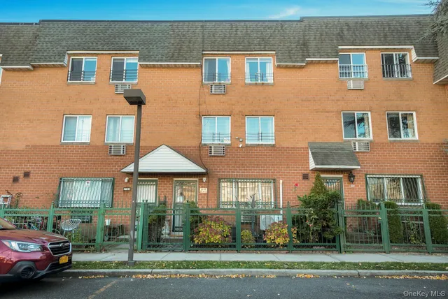 a front view of a residential apartment building with a yard