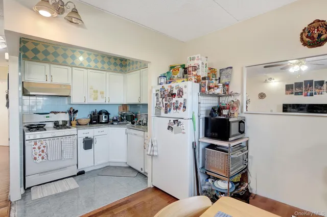 a kitchen with cabinets and chairs