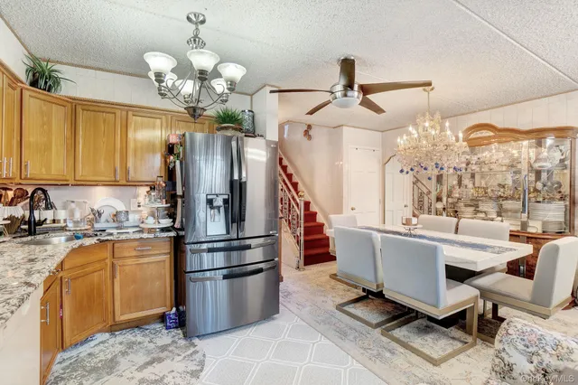 a kitchen with refrigerator and cabinets