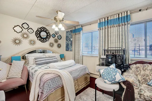 a bedroom with a bed and ceiling fan