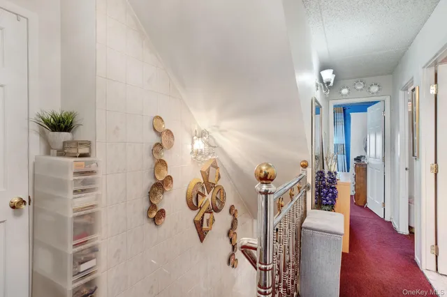a view of a hallway with wooden floor and entryway