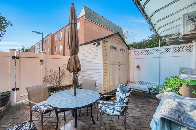 a backyard of a house with table and chairs