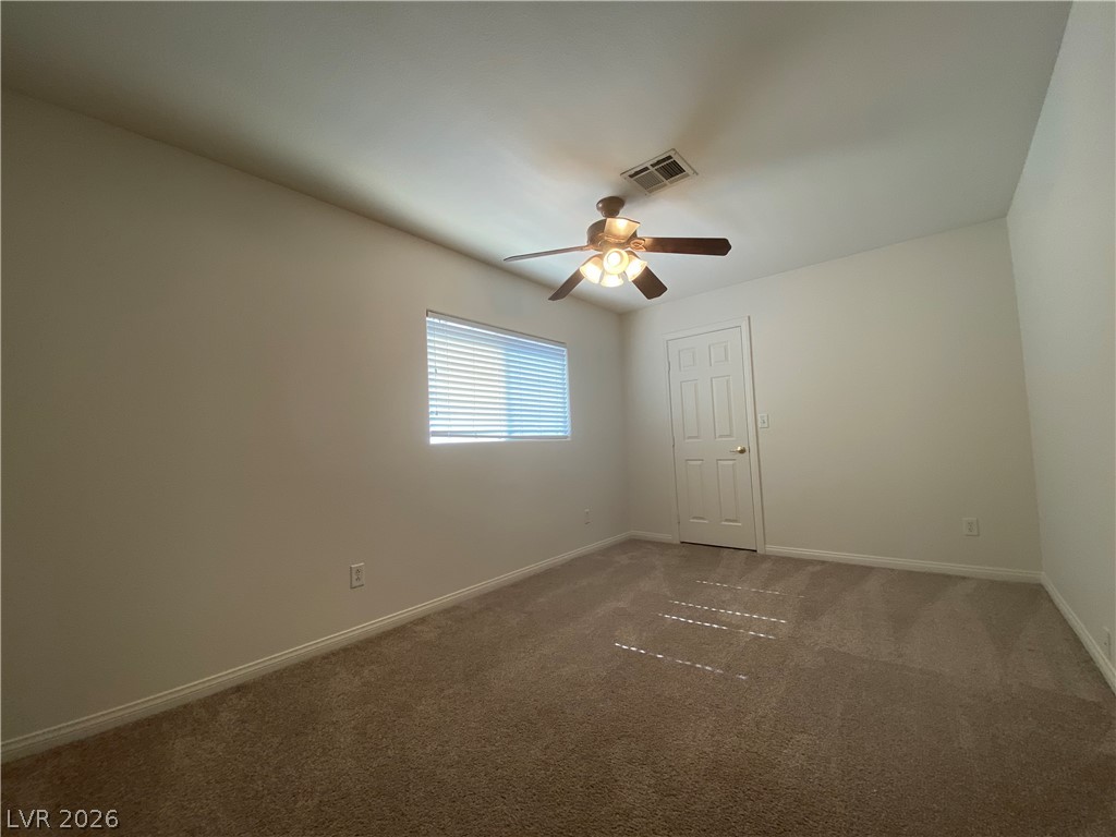 2023 Peacemaker Road Las Vegas, NV 89183 - Photo 13 of 24 Plush carpeting anchors this versatile room illuminated by natural light from a central window.