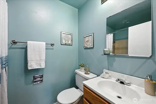 a bathroom with a sink mirror and toilet