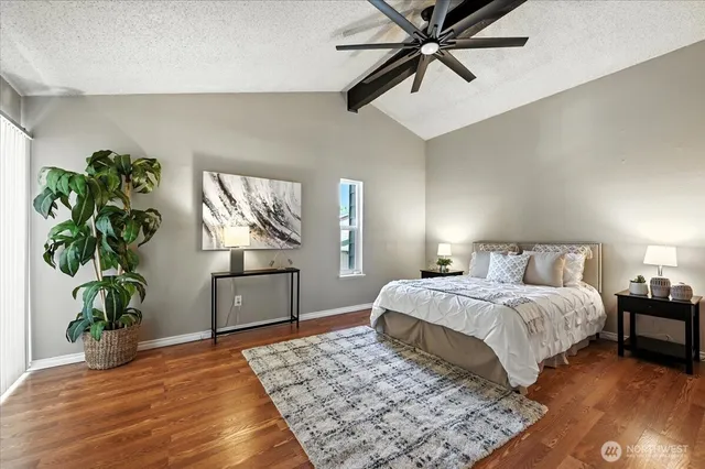 a bedroom with a bed dresser and a potted plant