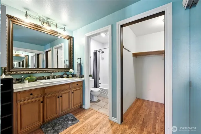 a bathroom with a double vanity sink and a mirror