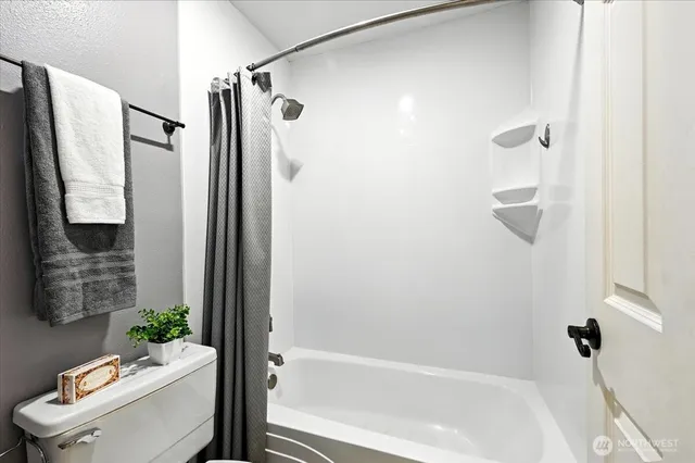 a bathroom with a tub and a shower