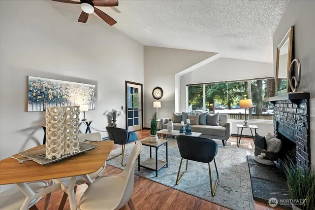 a living room with fireplace furniture and a floor to ceiling window