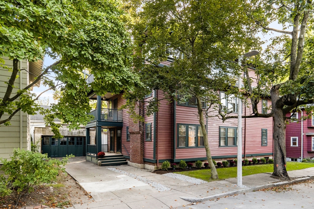 a front view of a house with garden