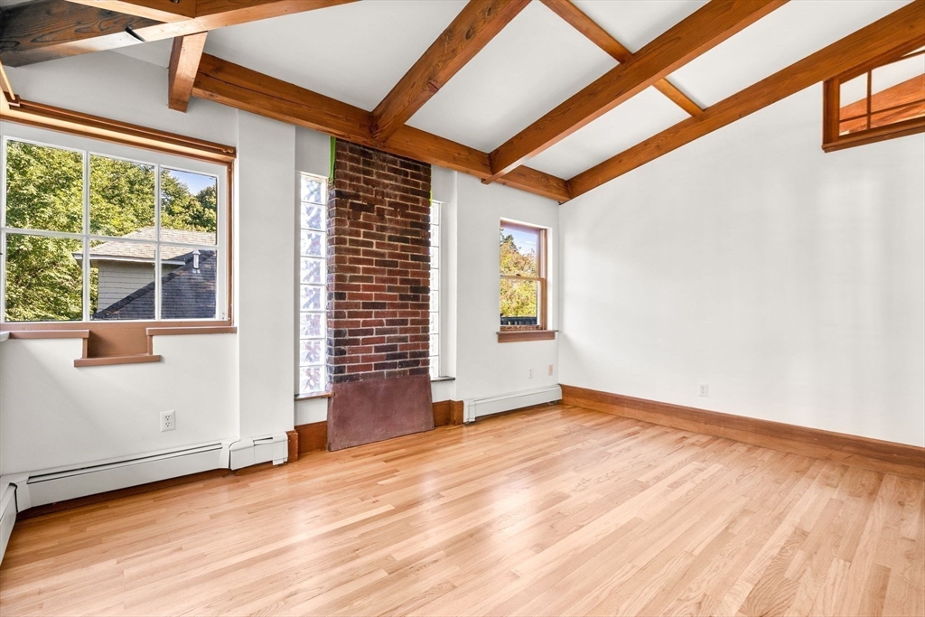 30-32 Goodrich Road Boston, MA 02130 - Photo 11 of 39 an empty room with wooden floor and windows
