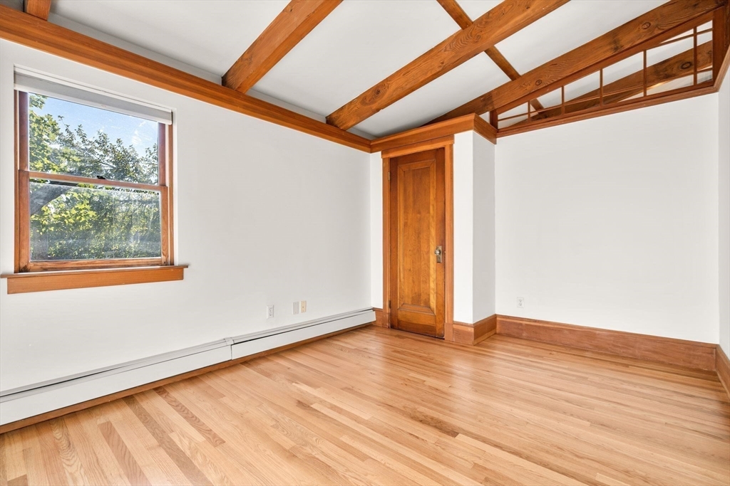 30-32 Goodrich Road Boston, MA 02130 - Photo 12 of 39 a view of an empty room with wooden floor and a window