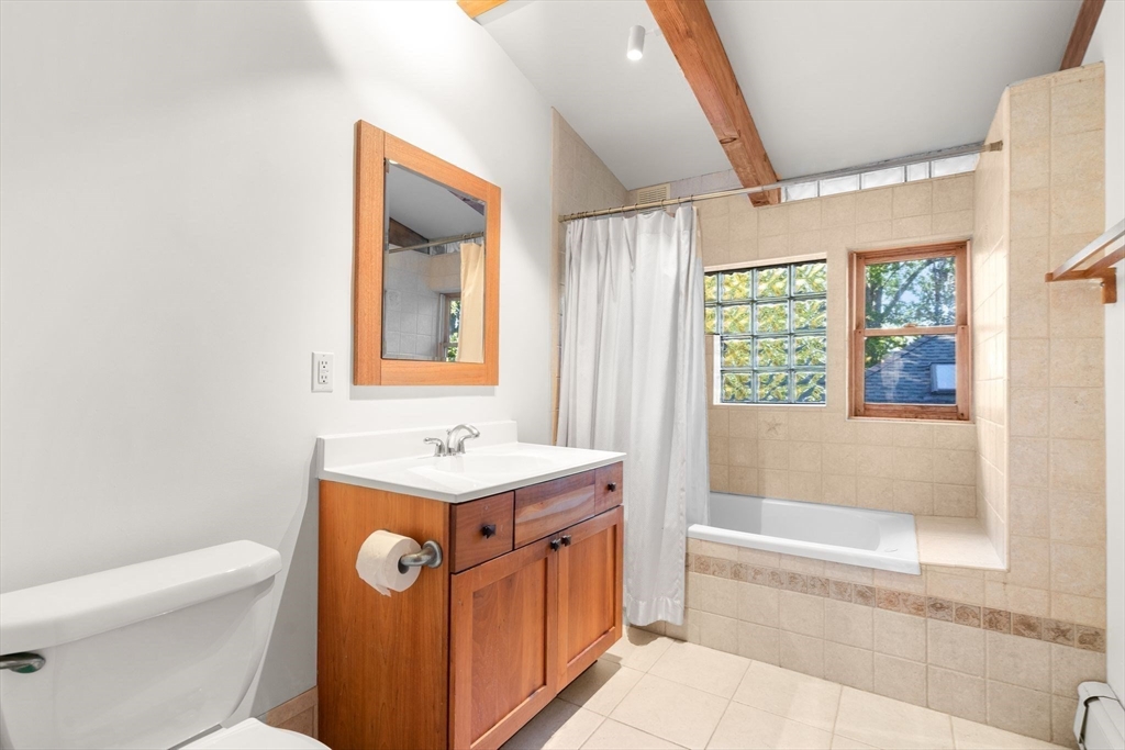 30-32 Goodrich Road Boston, MA 02130 - Photo 13 of 39 a bathroom with a sink a mirror toilet and bathtub