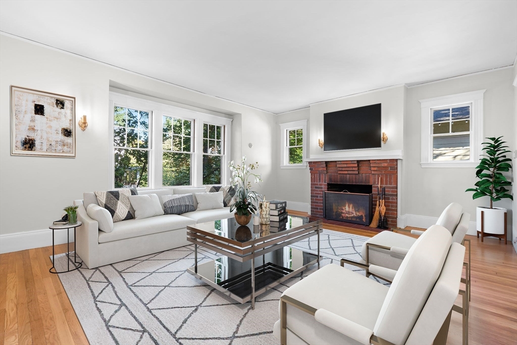30-32 Goodrich Road Boston, MA 02130 - Photo 15 of 39 a living room with furniture a flat screen tv and a fireplace