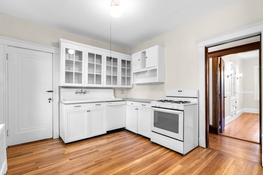 30-32 Goodrich Road Boston, MA 02130 - Photo 18 of 39 a kitchen with stainless steel appliances granite countertop a stove and a sink