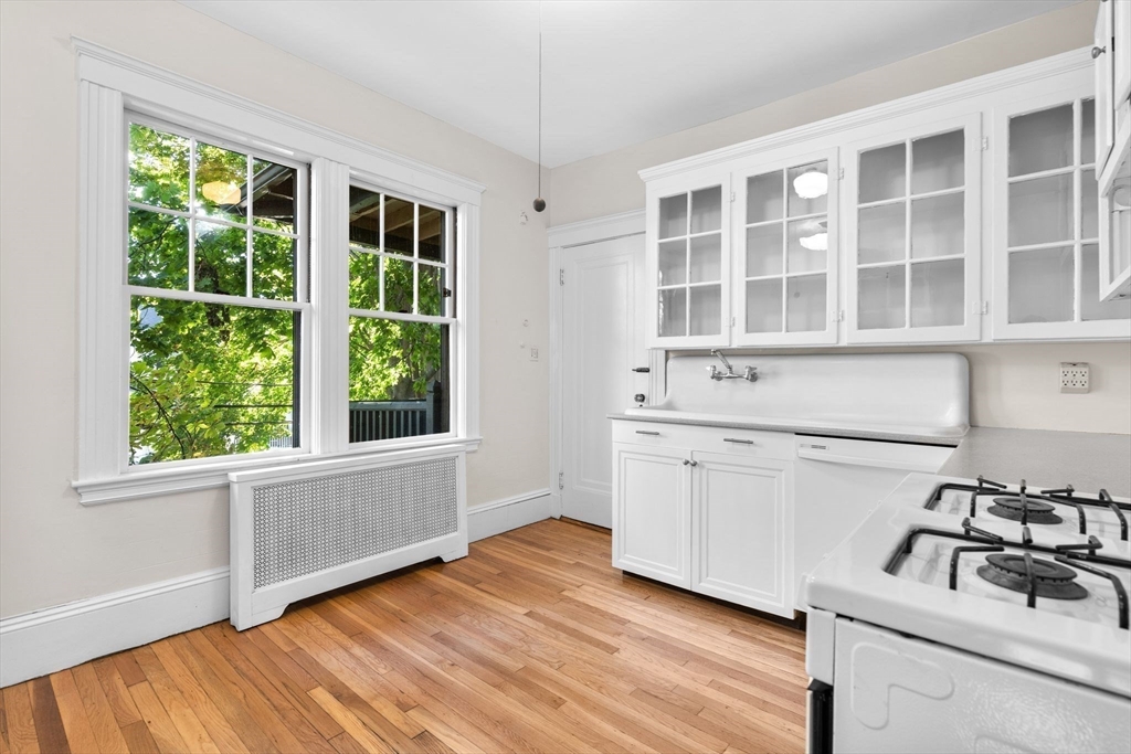 30-32 Goodrich Road Boston, MA 02130 - Photo 19 of 39 a kitchen with a sink wooden floor and windows