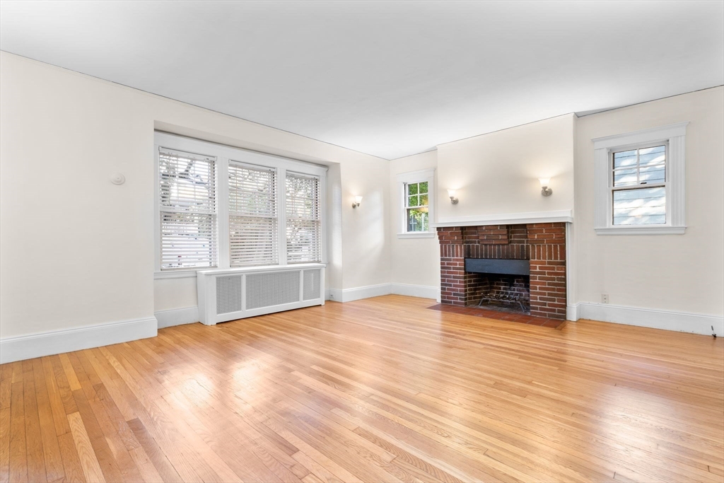 30-32 Goodrich Road Boston, MA 02130 - Photo 25 of 39 a view of empty room with wooden floor and fireplace