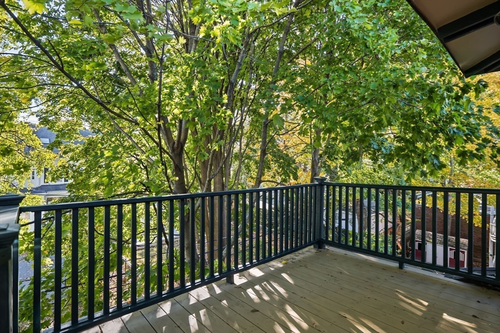 30-32 Goodrich Road Boston, MA 02130 - Photo 35 of 39 a balcony with wooden floor and fence