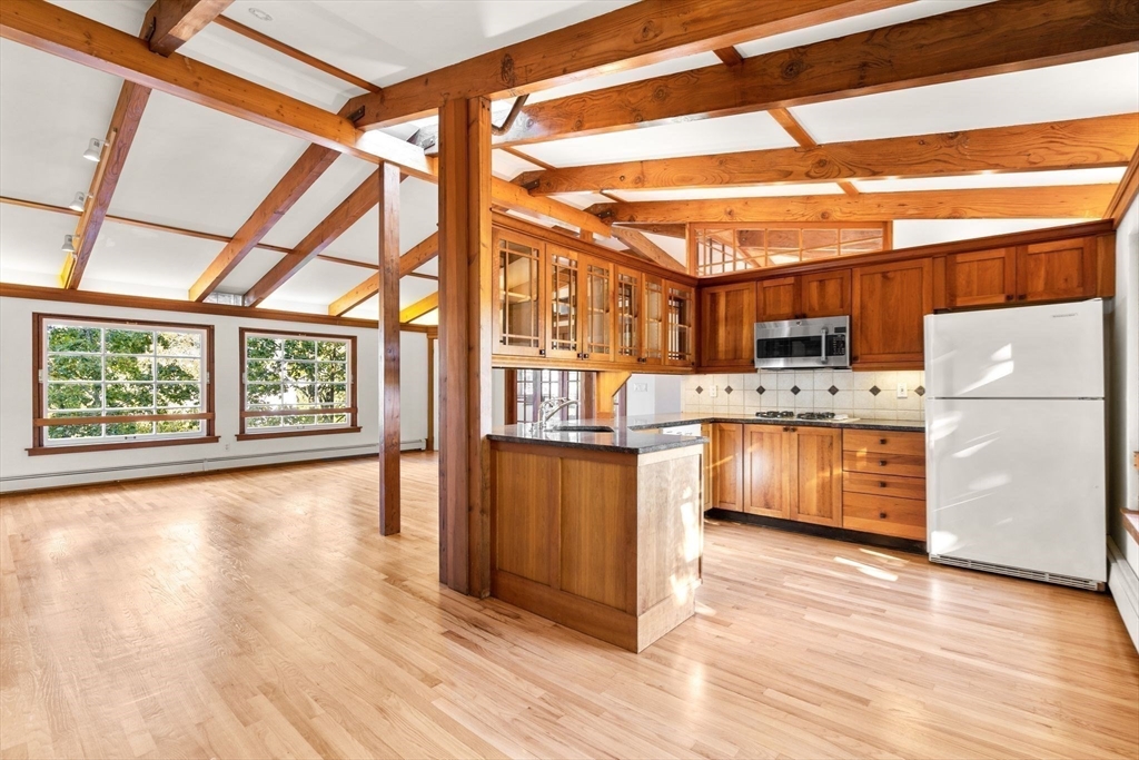 30-32 Goodrich Road Boston, MA 02130 - Photo 6 of 39 a kitchen with stainless steel appliances a stove a sink and a refrigerator