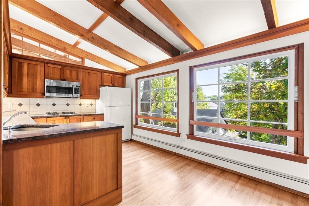 30-32 Goodrich Road Boston, MA 02130 - Photo 7 of 39 a kitchen with stainless steel appliances a refrigerator and a stove top oven