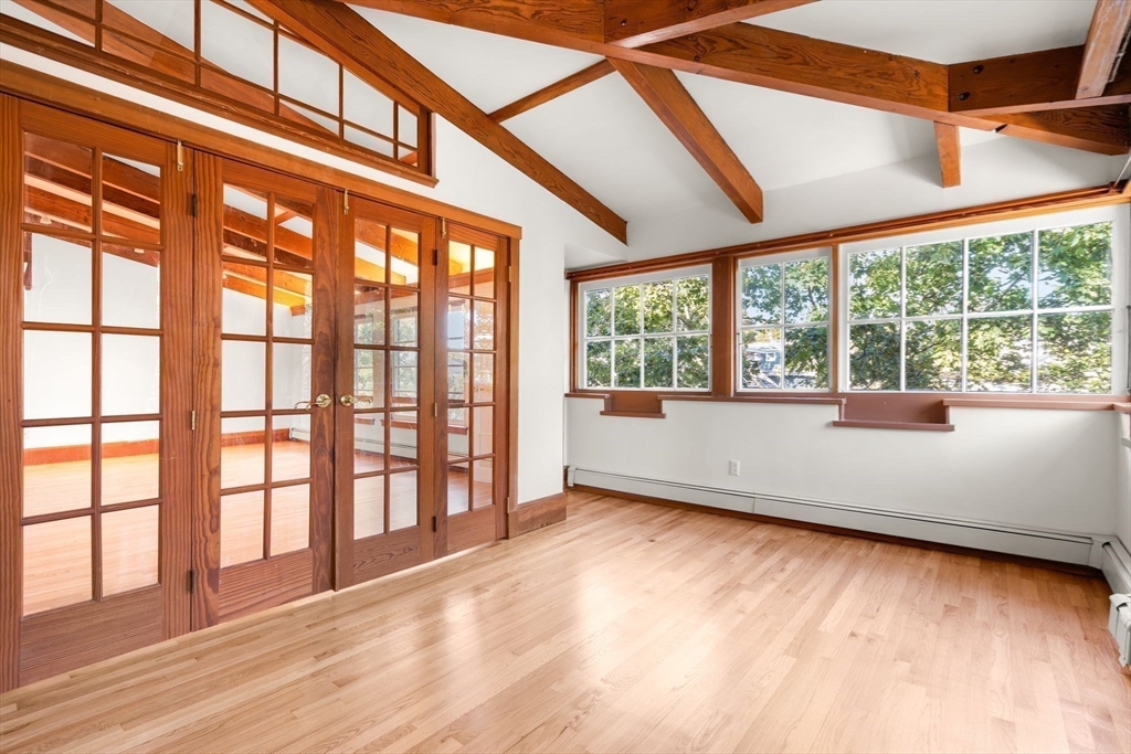 30-32 Goodrich Road Boston, MA 02130 - Photo 10 of 39 an empty room with wooden floor and doors