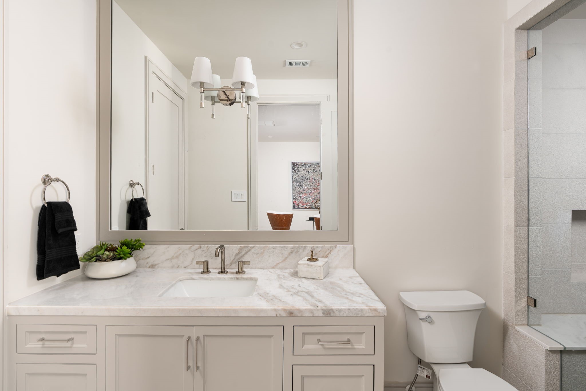 1215 West Pierce Street Houston, TX 77019 - Photo 13 of 40 Each secondary, en-suite bathroom features custom-built cabinetry, marble counters, Brizo Litze polished nickel fixtures, and a unique tile design.