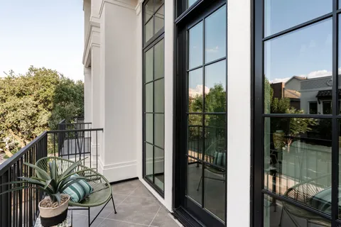 a dining room with furniture a chandelier and wooden floor