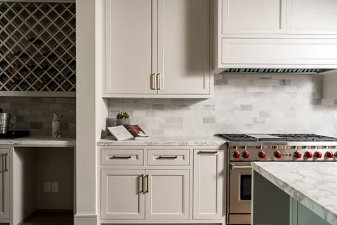 a kitchen with a sink a stove and cabinets