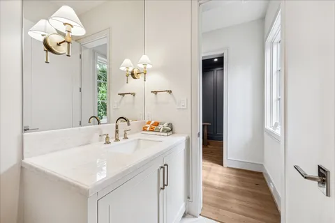 a dining room with furniture a potted plant and wooden floor