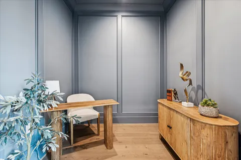 a view of a bedroom with wooden floor and a couch