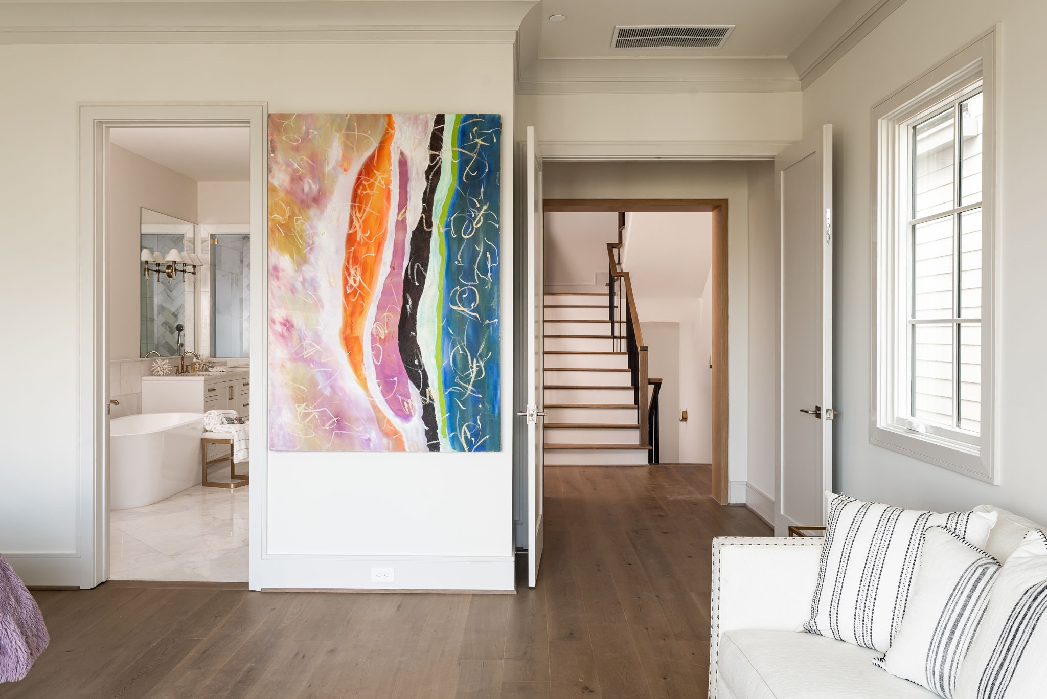 1215 West Pierce Street Houston, TX 77019 - Photo 26 of 40 The primary bedroom has a wide entrance, framed with white oak. It opens onto a luxurious primary bathroom with a truly magnificent primary closet beyond.